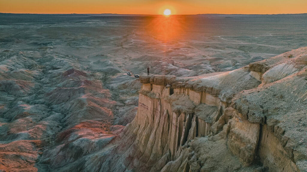 Sunset over dramatic cliffs in the Mongolian desert.