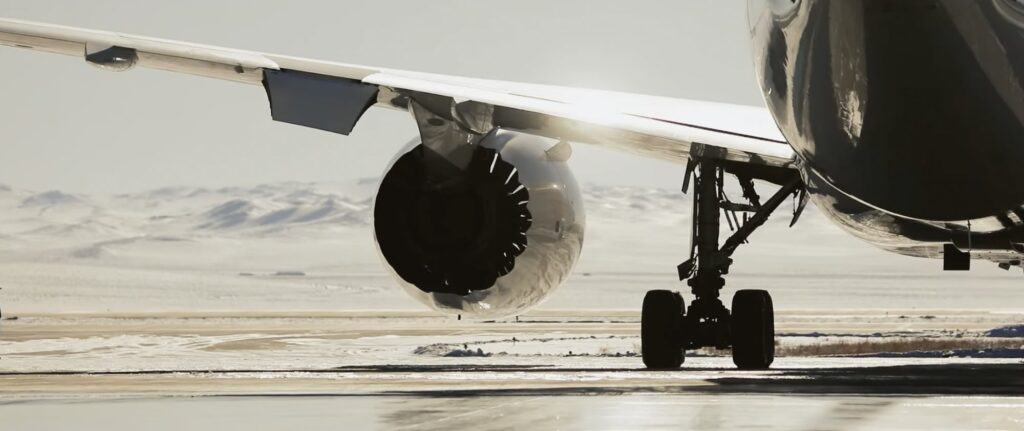 A close up of an airplane engine as the plane leaves Ulanbaatar