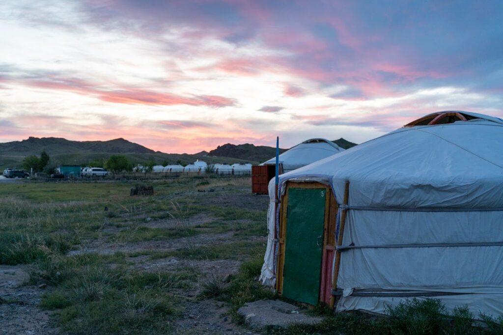 A mongolian ger camp at sunset.