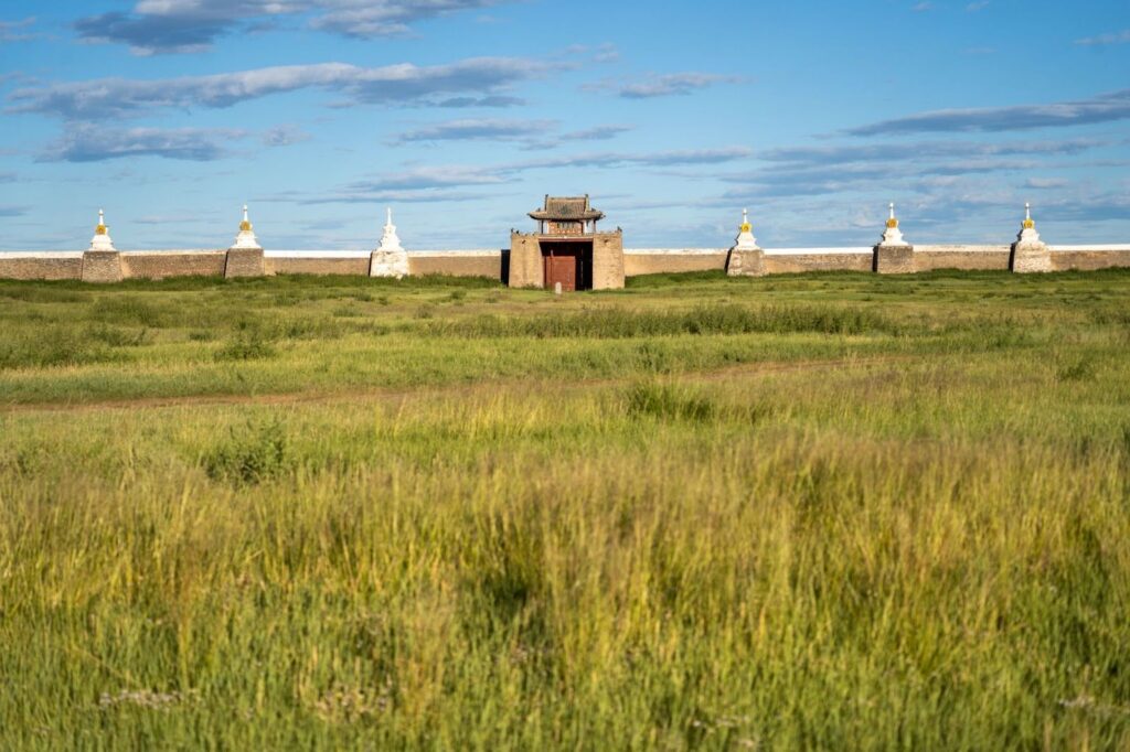 Ancient walls in a grassy meadow in Mongolia. One of the best things to do in the country.