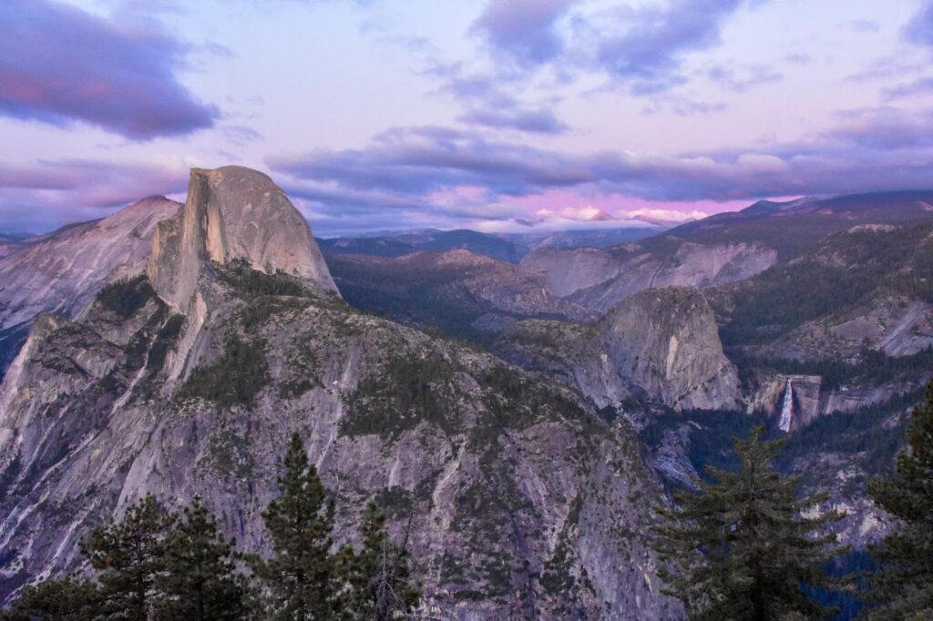 Yosemite viewpoint at sunset so the rocks look purple.