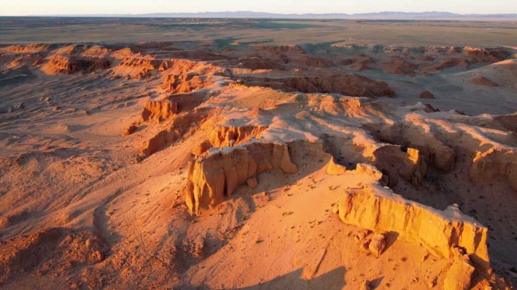 Flaming cliffs in Mongolia cast in an orange glow.