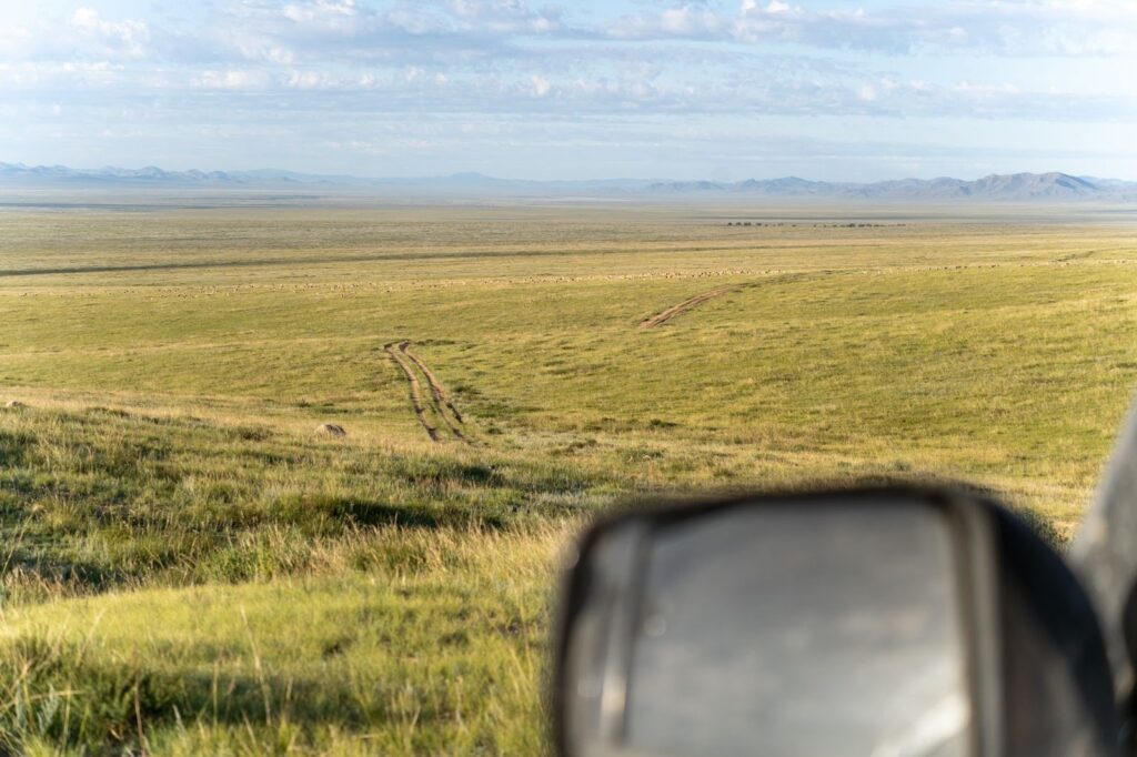 An off-road track viewed through the window a car in Mongolia.