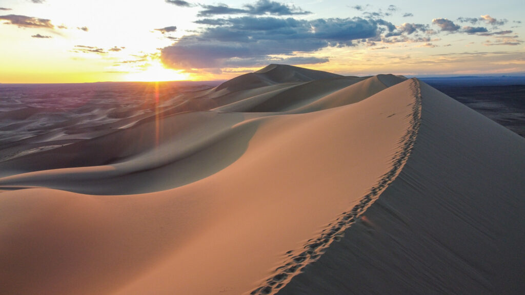 tall sand dune at sunset 