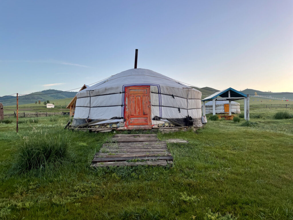 scenic ger hut with the sun behind it 