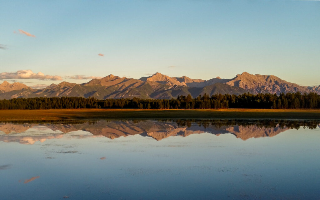 Mountains reflected in a lake at sunset 