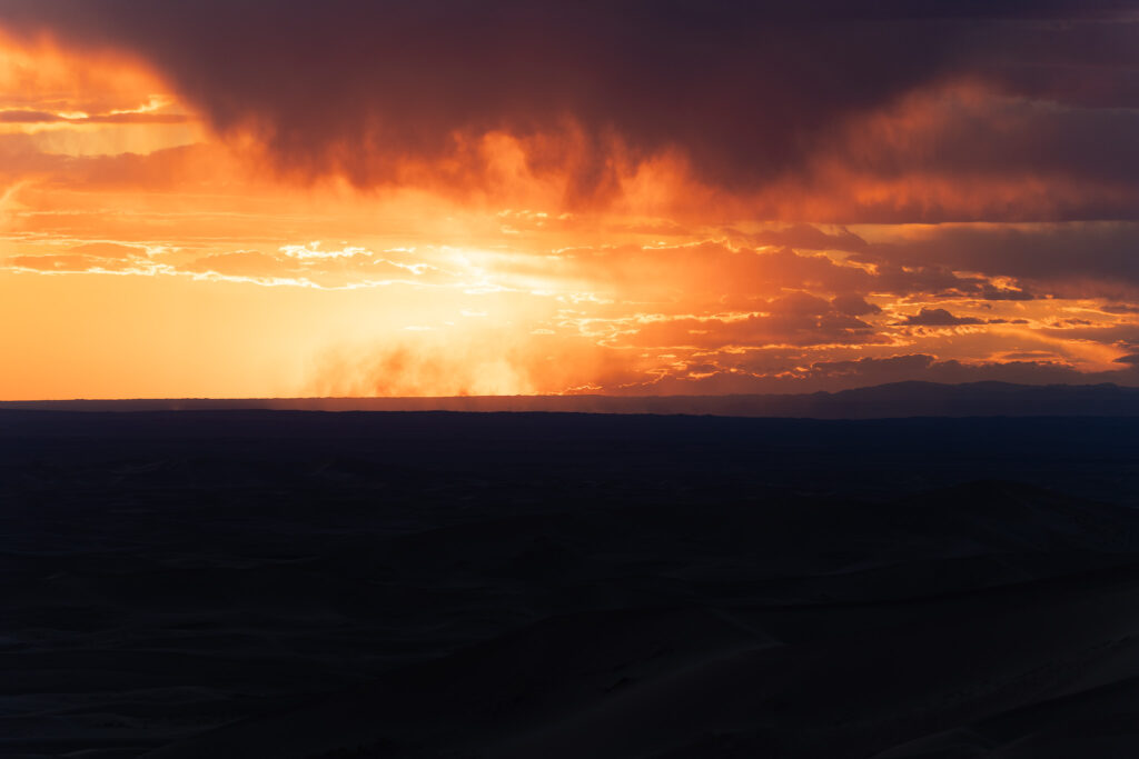 Bright sunset with a dark foreground in the Gobi Desert